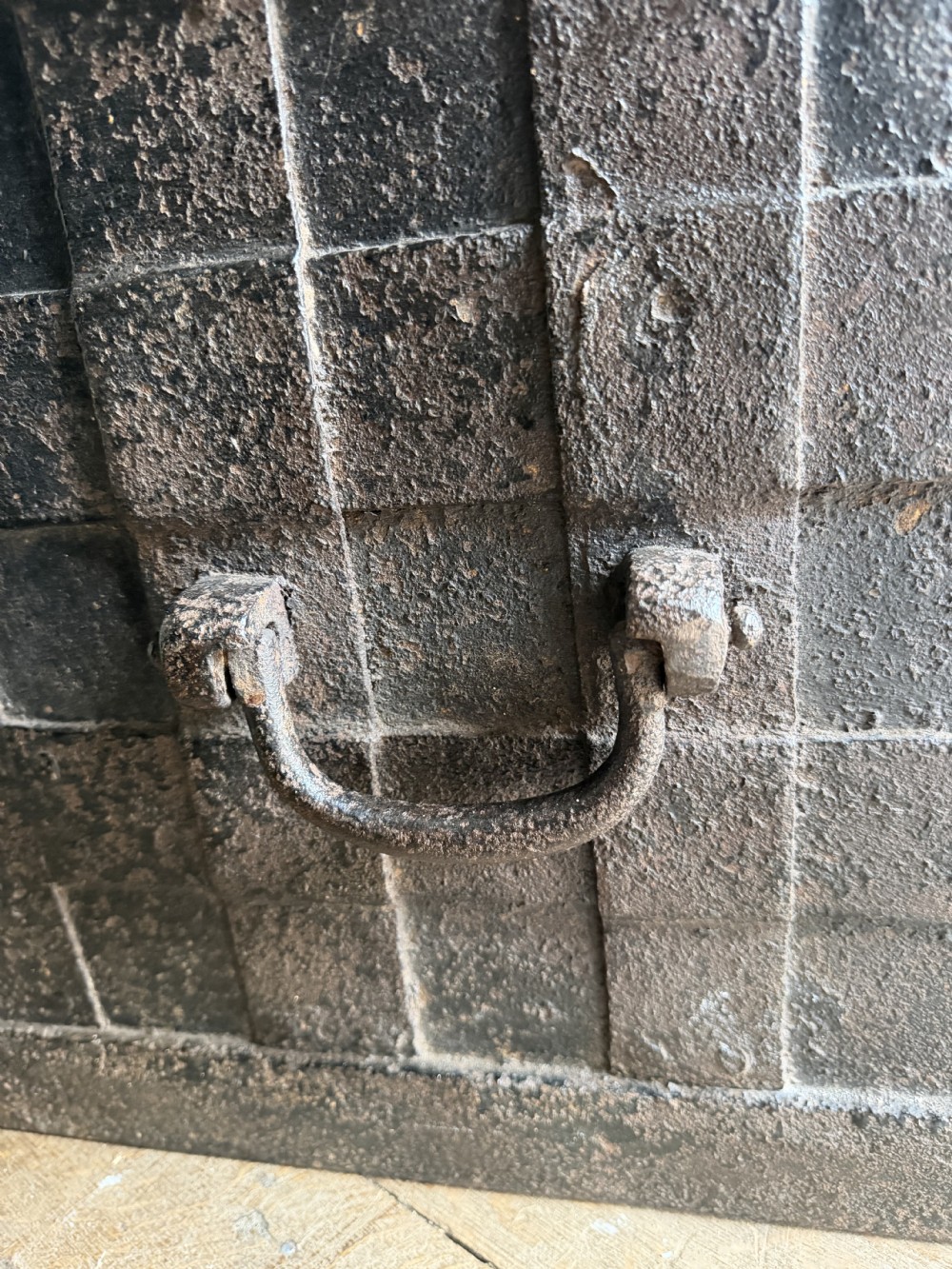 A rectangular late seventeenth-century wrought iron strongbox with criss-crossing riveted bands and a heavy central iron locking hasp. View VI