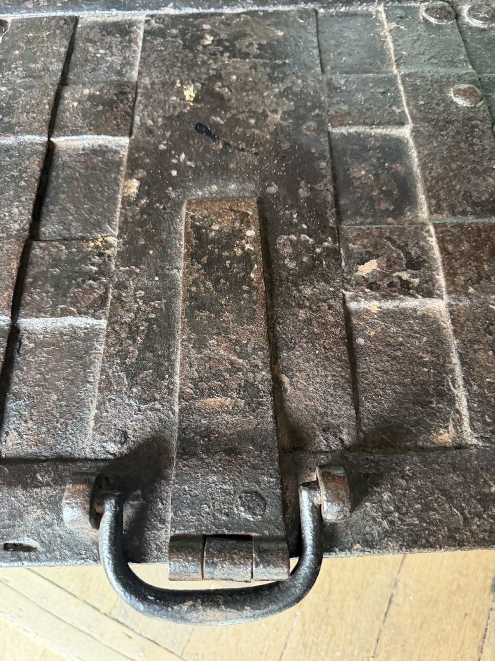 A rectangular late seventeenth-century wrought iron strongbox with criss-crossing riveted bands and a heavy central iron locking hasp. View VIII