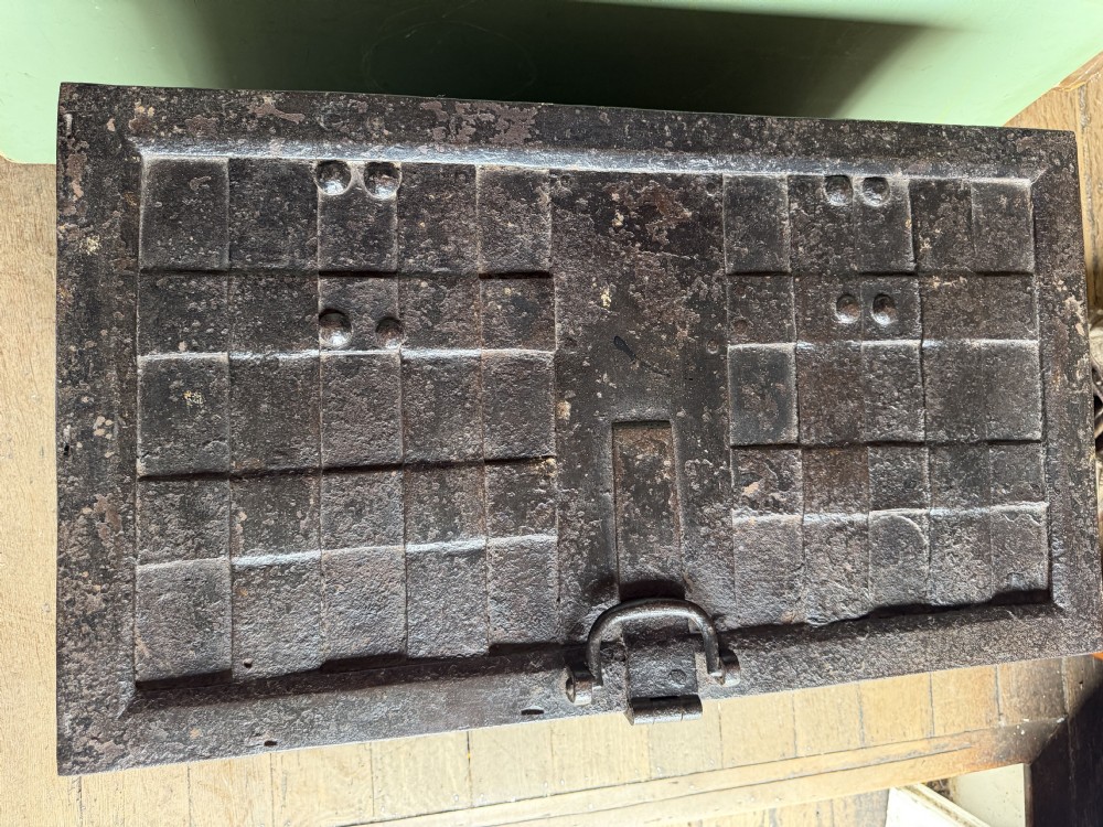 A rectangular late seventeenth-century wrought iron strongbox with criss-crossing riveted bands and a heavy central iron locking hasp. View XVI
