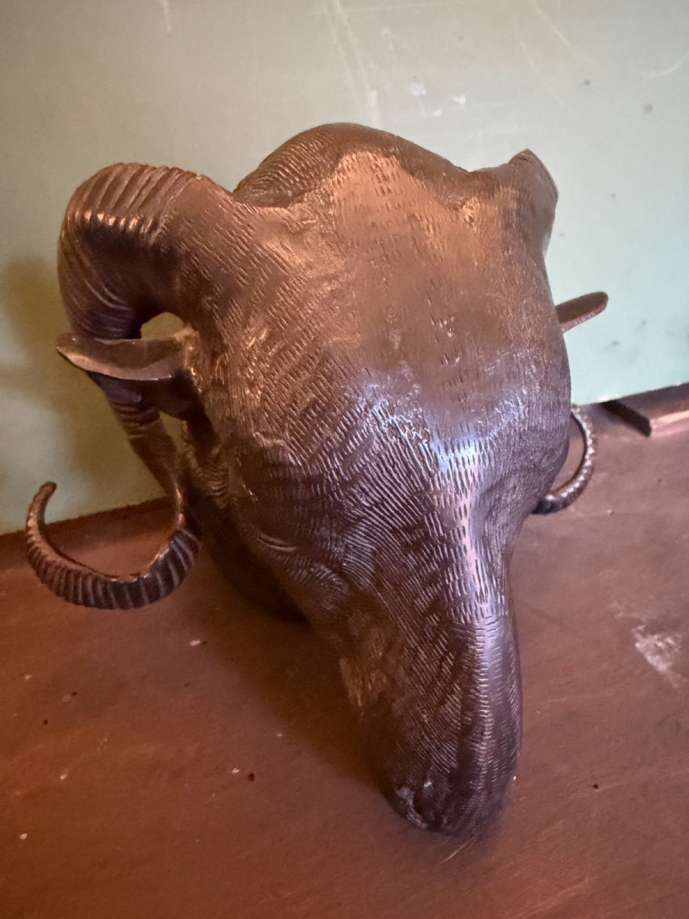 A late 19th-century cast bronze study featuring a ram head with detailed spiralled horns and textured fleece. View II