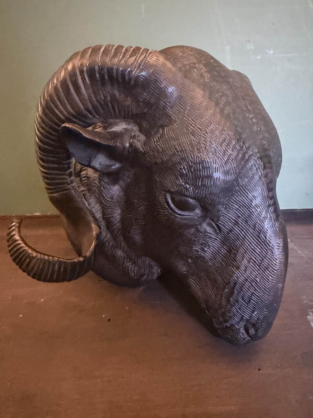 A late 19th-century cast bronze study featuring a ram head with detailed spiralled horns and textured fleece. View IX