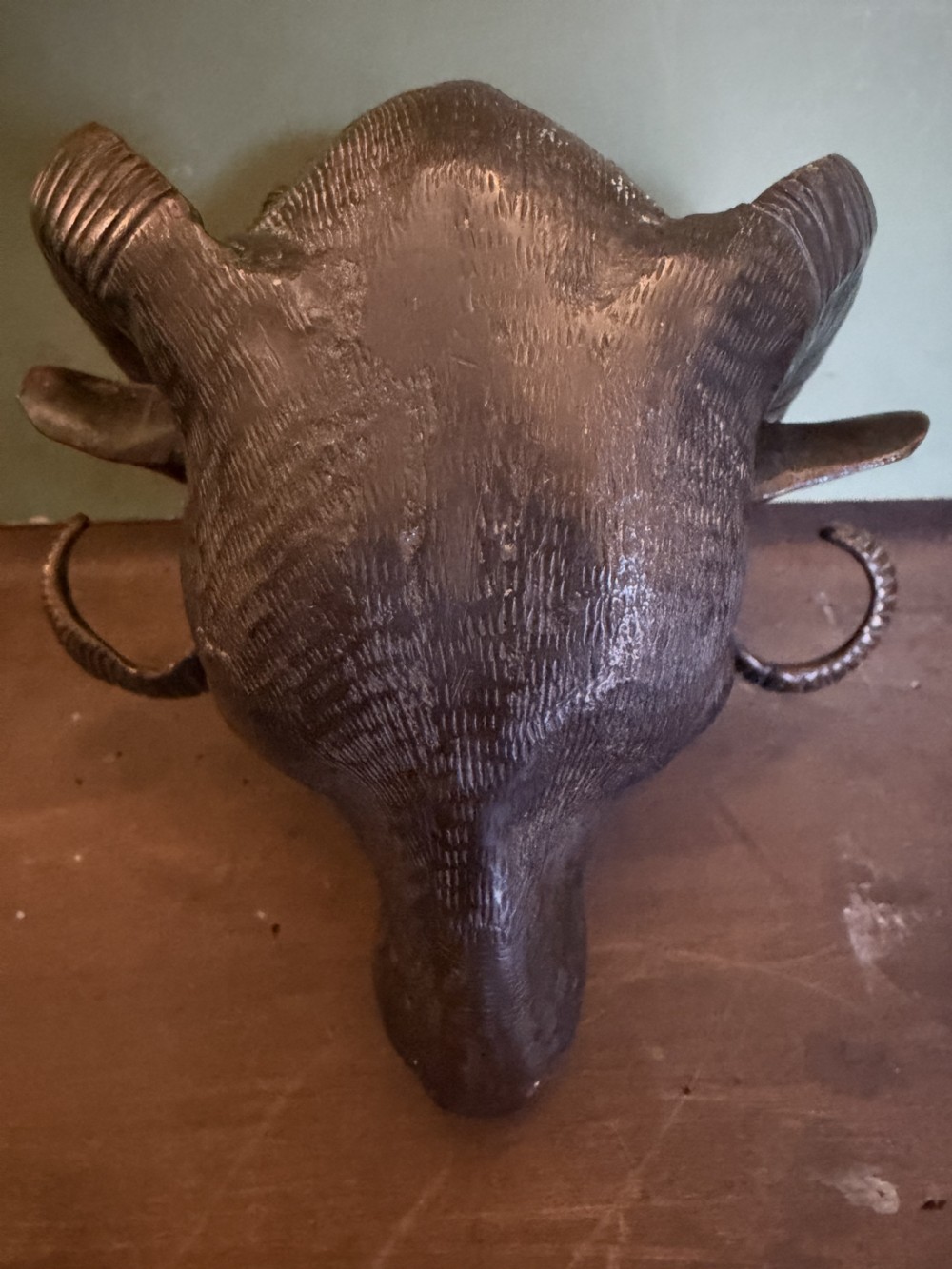 A late 19th-century cast bronze study featuring a ram head with detailed spiralled horns and textured fleece. View X