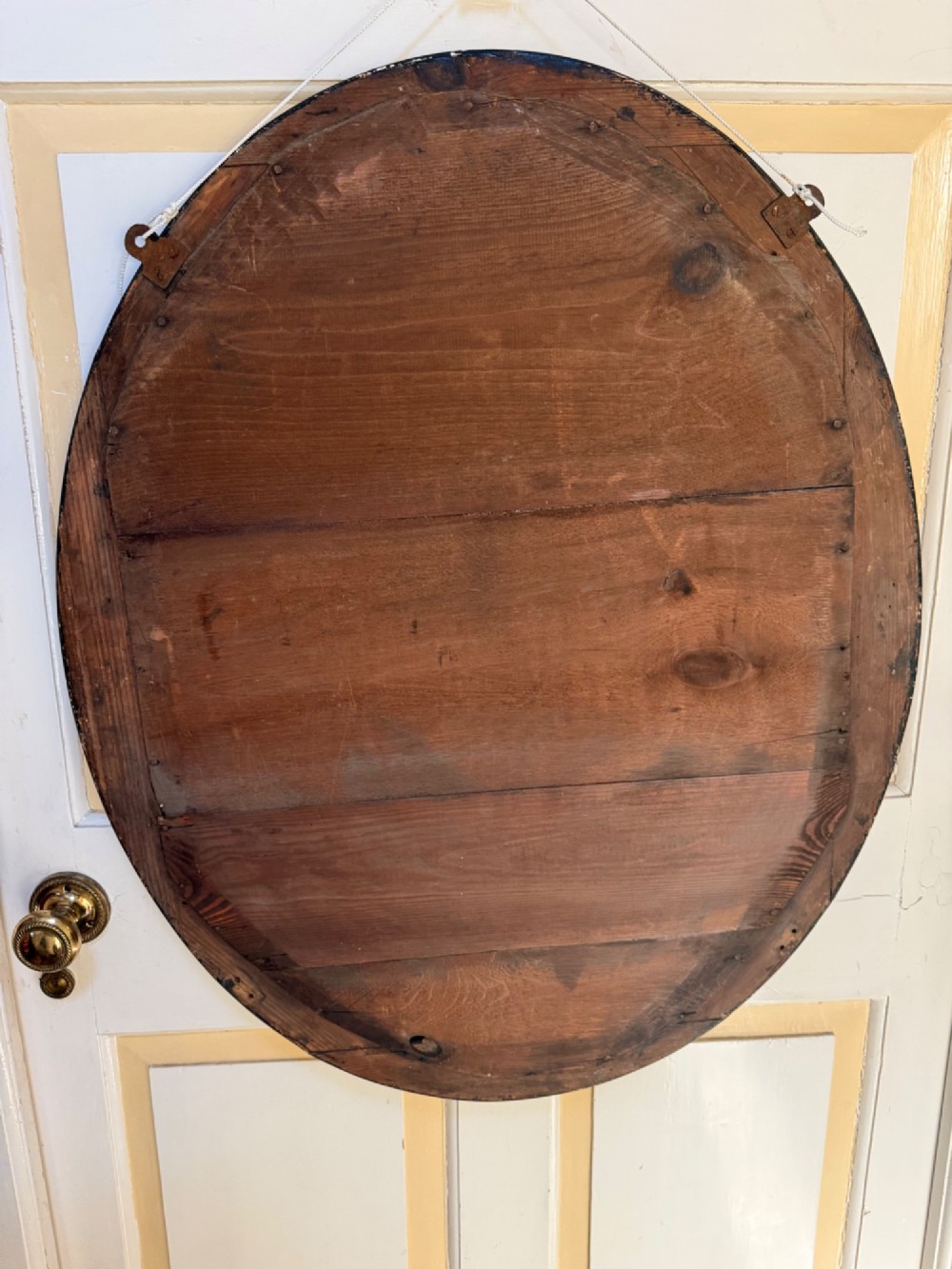 A nineteenth-century Irish oval wall mirror featuring an ebonised frame inset with clear facetted glass jewels, an inner silver-gilt band, and cobalt blue glass cabochons. View VIII
