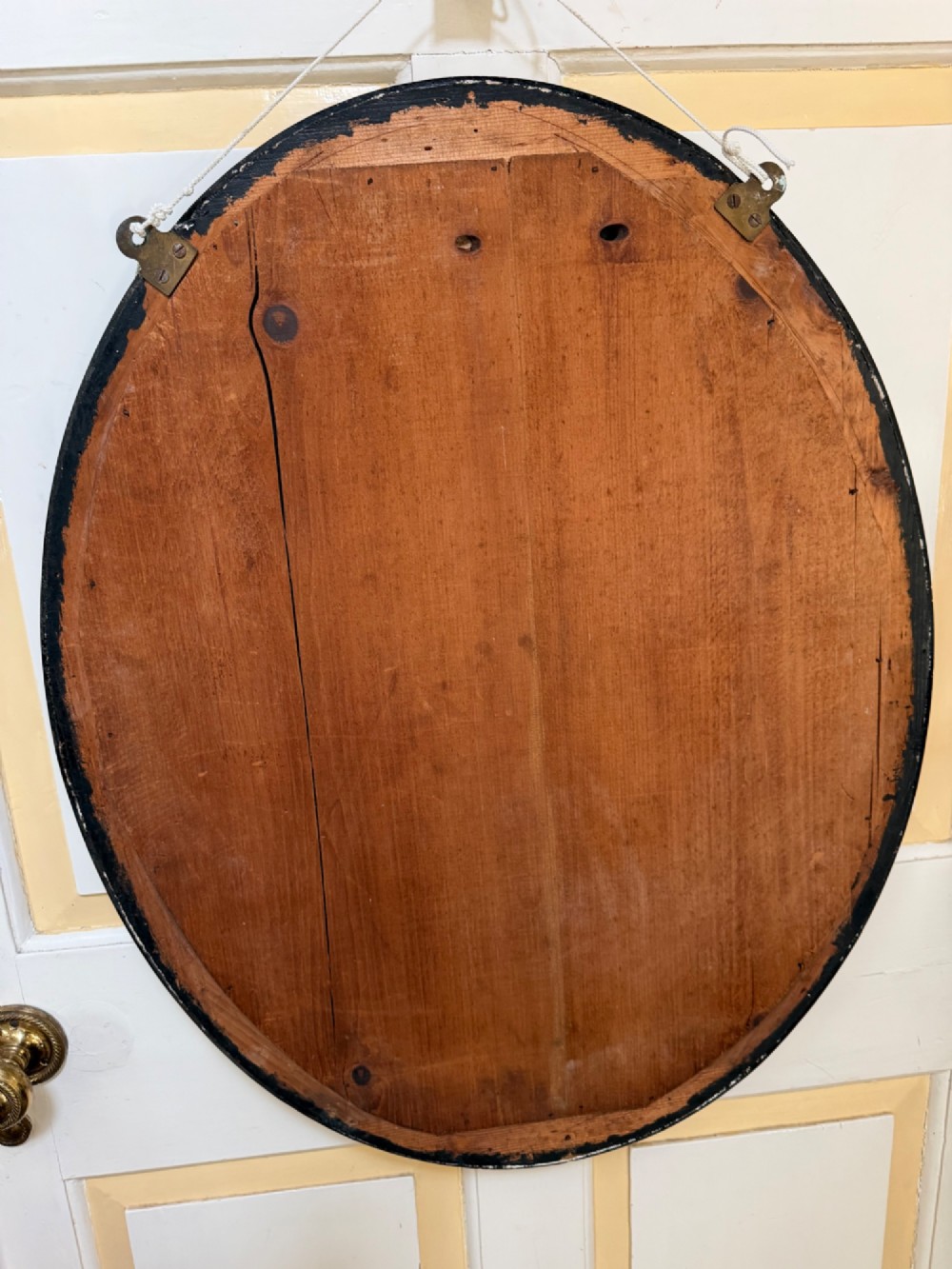 An early nineteenth-century Irish oval wall mirror featuring an ebonised and silver-gilt frame embellished with an outer border of faceted glass cabochons. View IX