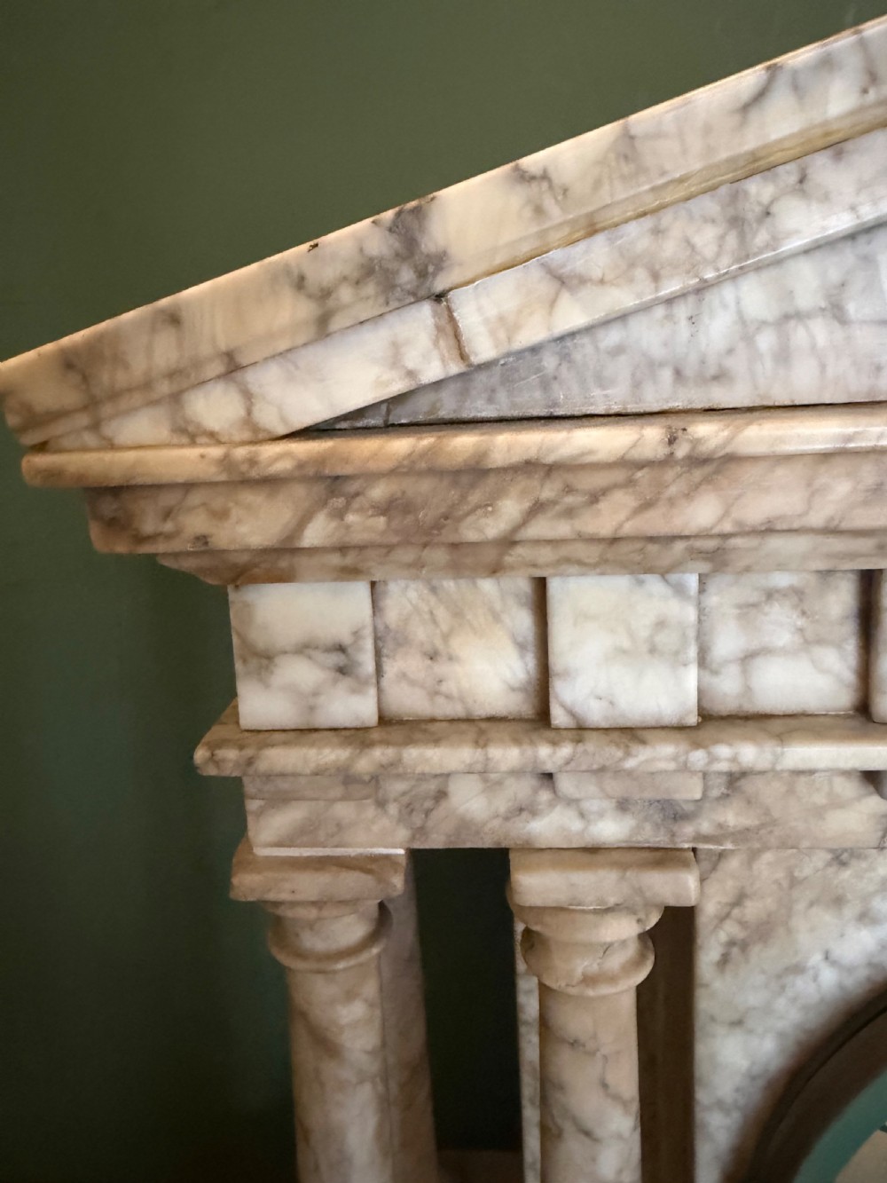 A late nineteenth-century carved cream alabaster mantel clock styled as a classical Greek temple with columns and a central brass dial. View VII