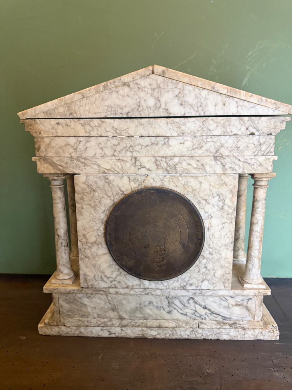 A late nineteenth-century carved cream alabaster mantel clock styled as a classical Greek temple with columns and a central brass dial. View IX