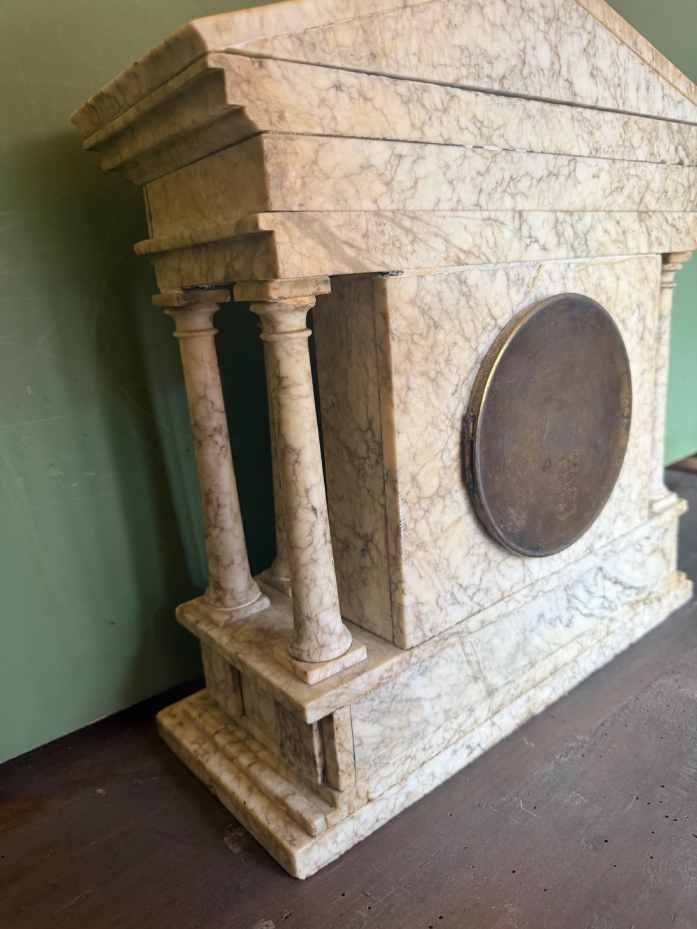 A late nineteenth-century carved cream alabaster mantel clock styled as a classical Greek temple with columns and a central brass dial. View X