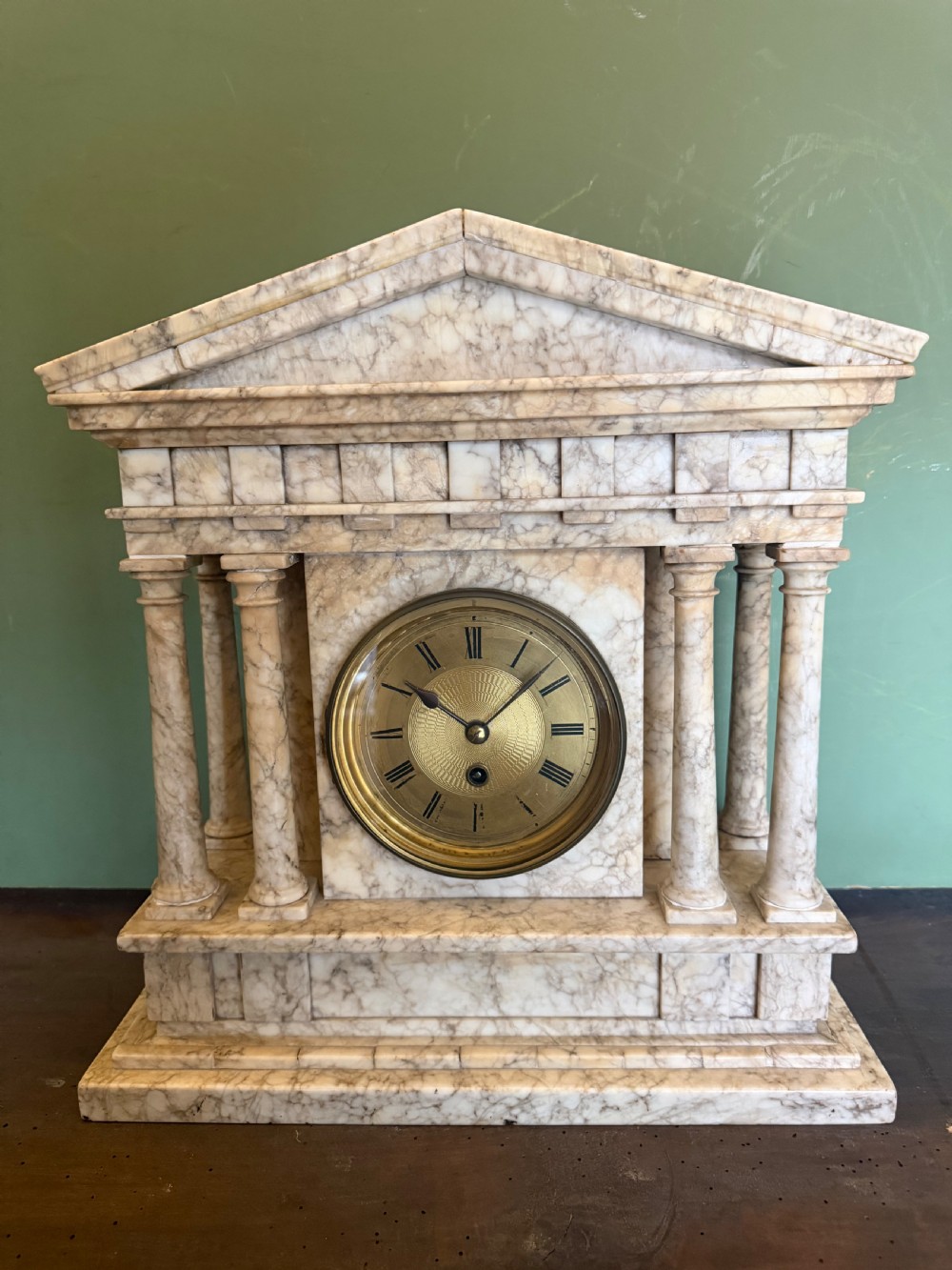 A late nineteenth-century carved cream alabaster mantel clock styled as a classical Greek temple with columns and a central brass dial. View XI