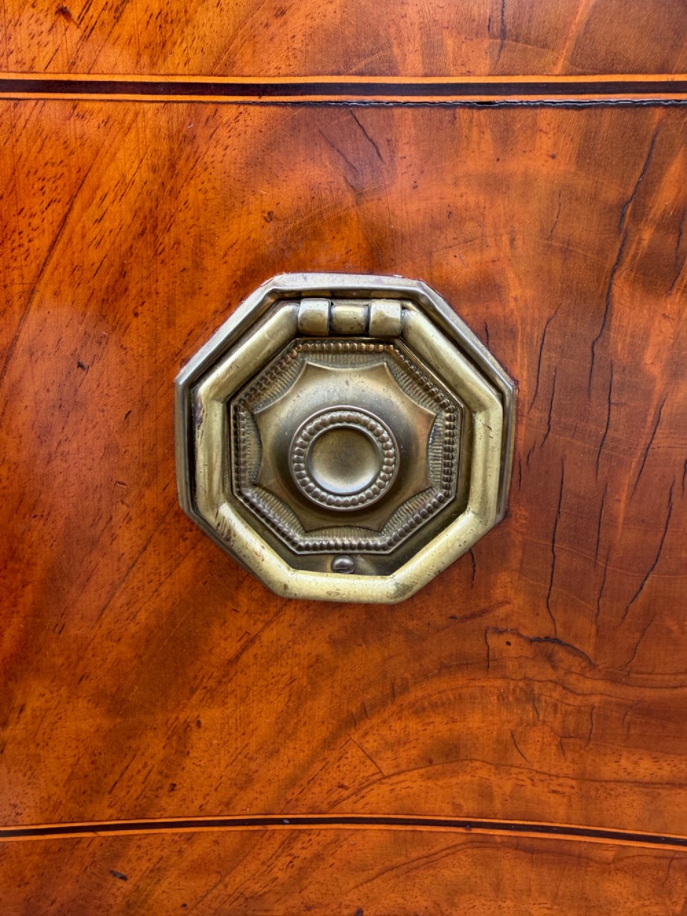 A late 18th-century George III mahogany sideboard featuring a serpentine front, stringing inlays, brass octagonal handles, and tapered square legs. View XIII