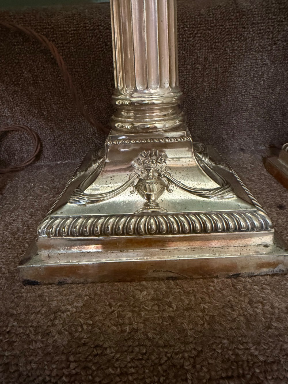 A pair of late nineteenth-century silver-plated table lamps designed as fluted Corinthian columns on square stepped bases with classical swag relief. View IV