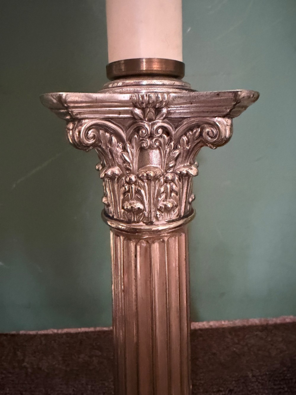 A pair of late nineteenth-century silver-plated table lamps designed as fluted Corinthian columns on square stepped bases with classical swag relief. View V