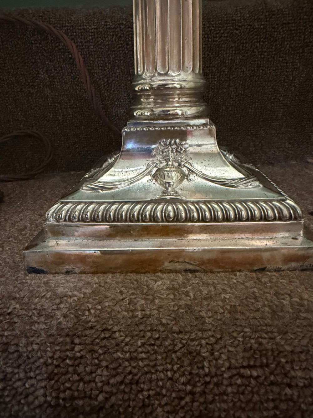A pair of late nineteenth-century silver-plated table lamps designed as fluted Corinthian columns on square stepped bases with classical swag relief. View IX