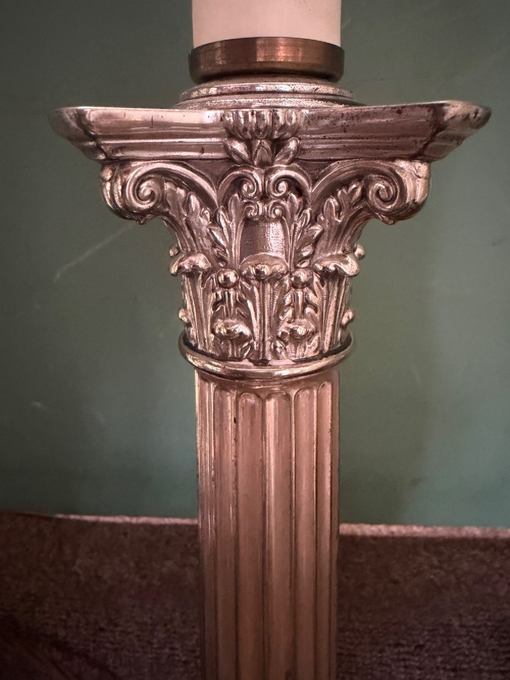 A pair of late nineteenth-century silver-plated table lamps designed as fluted Corinthian columns on square stepped bases with classical swag relief. View XI