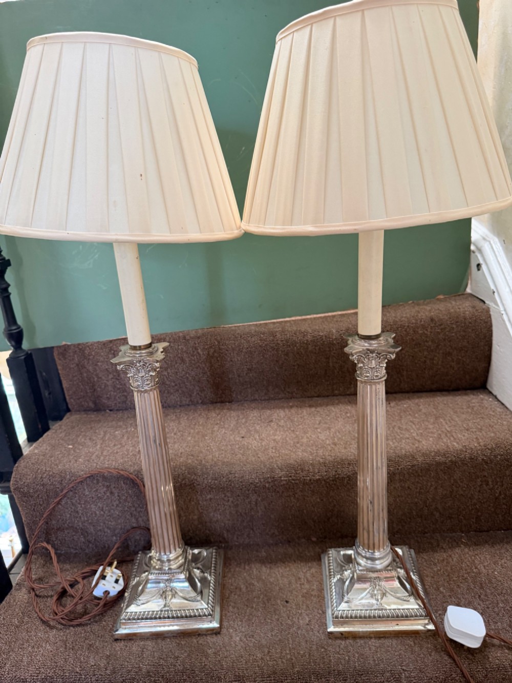 A pair of late nineteenth-century silver-plated table lamps designed as fluted Corinthian columns on square stepped bases with classical swag relief. View XIII