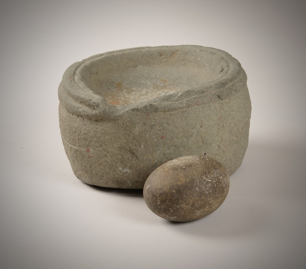 Early stone bowl and grinder.