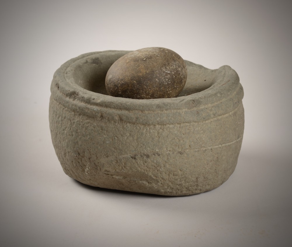 Early stone bowl and grinder. View II
