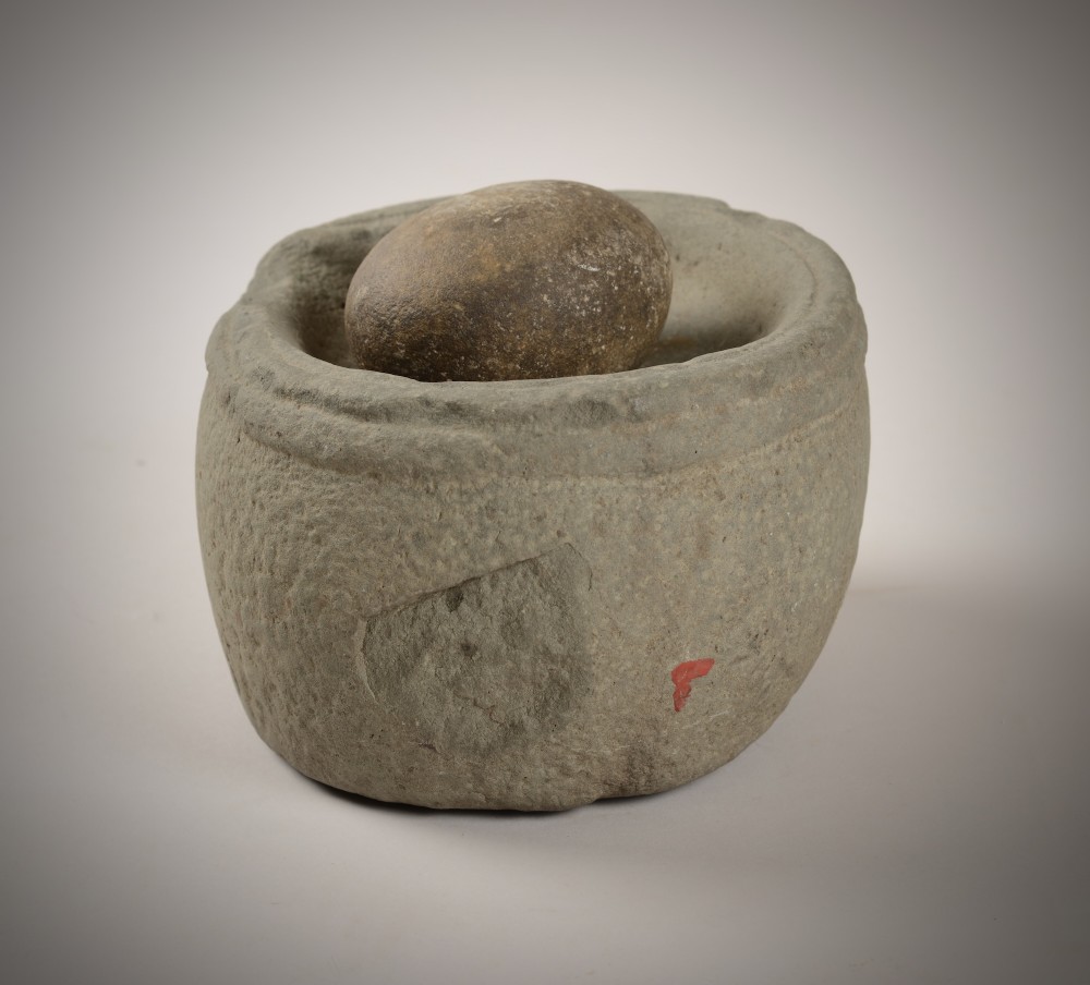 Early stone bowl and grinder. View III