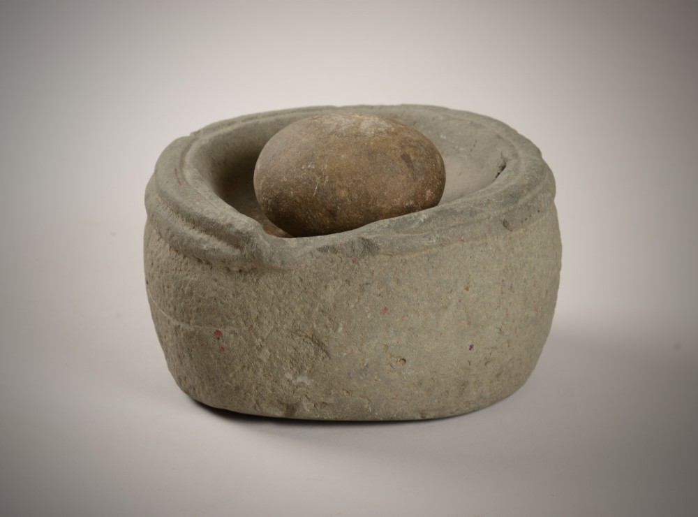 Early stone bowl and grinder. View IV