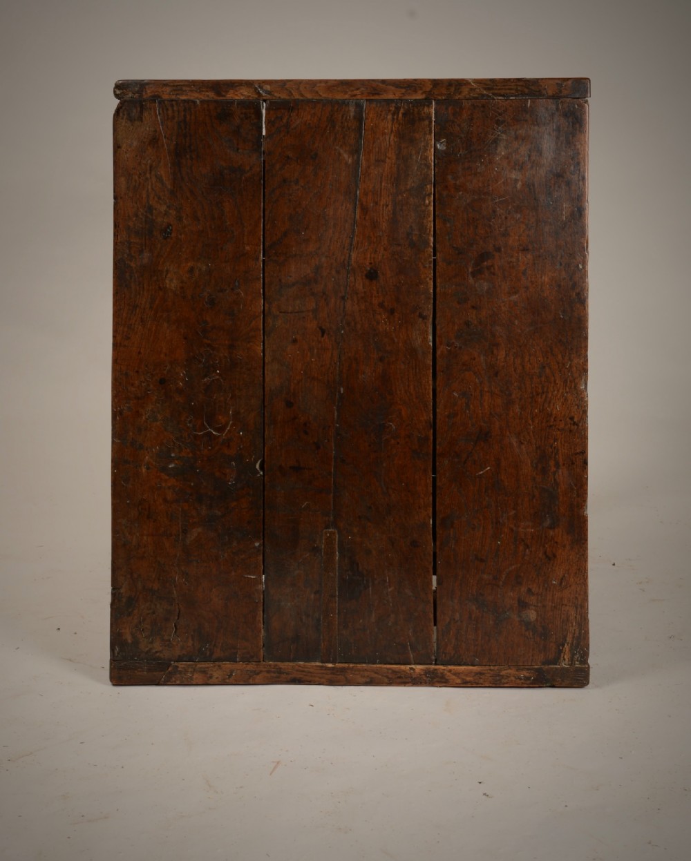 An antique dark oak low table featuring a plank top, a small side drawer with a brass drop handle, and sturdy legs joined by rectangular stretchers. View II