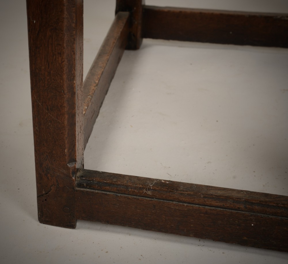 An antique dark oak low table featuring a plank top, a small side drawer with a brass drop handle, and sturdy legs joined by rectangular stretchers. View IV