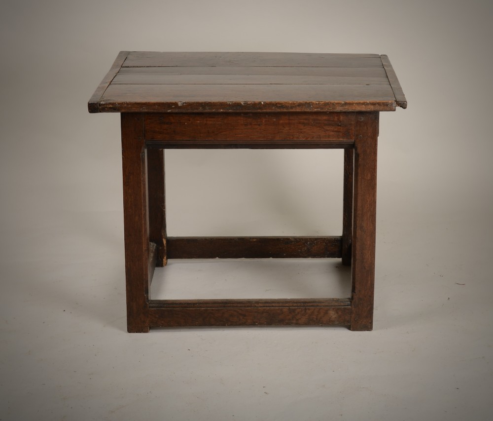 An antique dark oak low table featuring a plank top, a small side drawer with a brass drop handle, and sturdy legs joined by rectangular stretchers. View VII