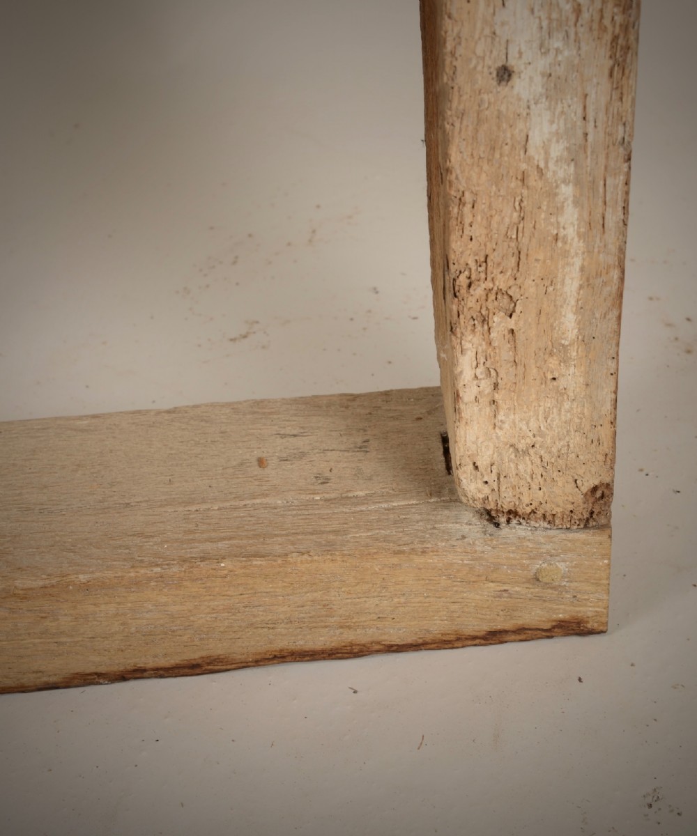 A hand-hewn oak Gothic window frame featuring a pointed arch apex and traditional pegged mortise joinery. View V