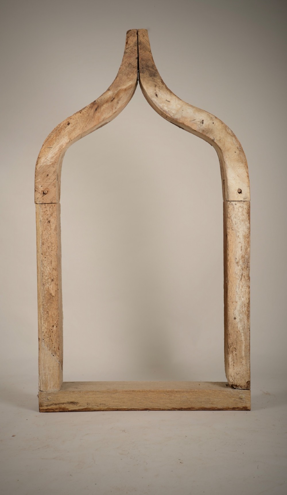 A hand-hewn oak Gothic window frame featuring a pointed arch apex and traditional pegged mortise joinery. View VII