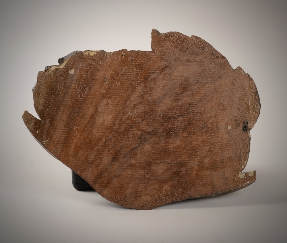 A carved wooden sculpture depicting the head of Saint John the Baptist resting on a circular charger platter. View II