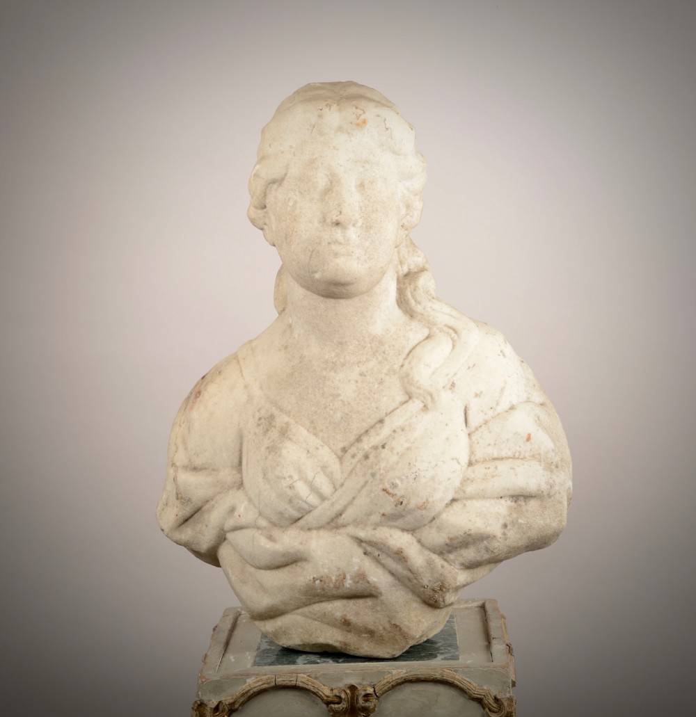 A carved off-white marble bust of a woman with classical draped clothing resting on a painted and gilded wooden pedestal. View IV