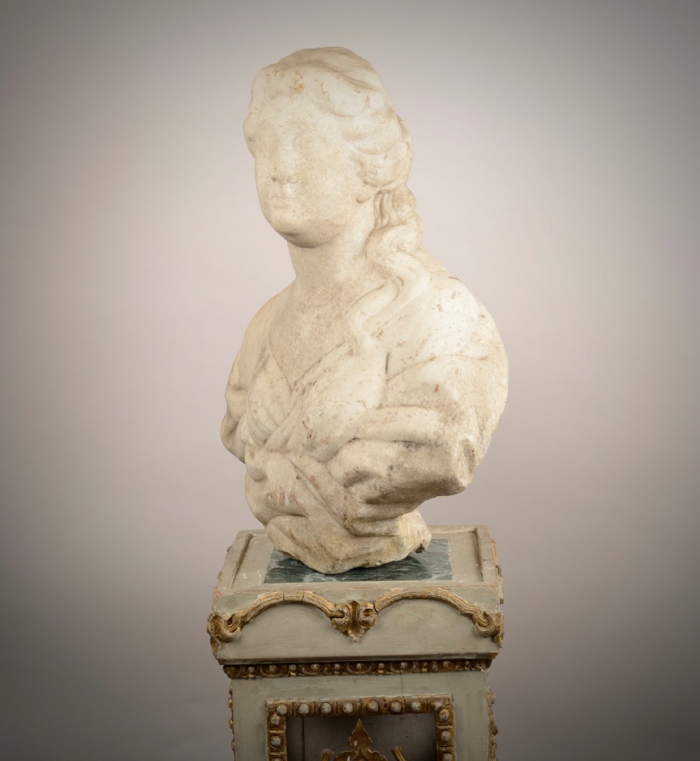 A carved off-white marble bust of a woman with classical draped clothing resting on a painted and gilded wooden pedestal. View VII