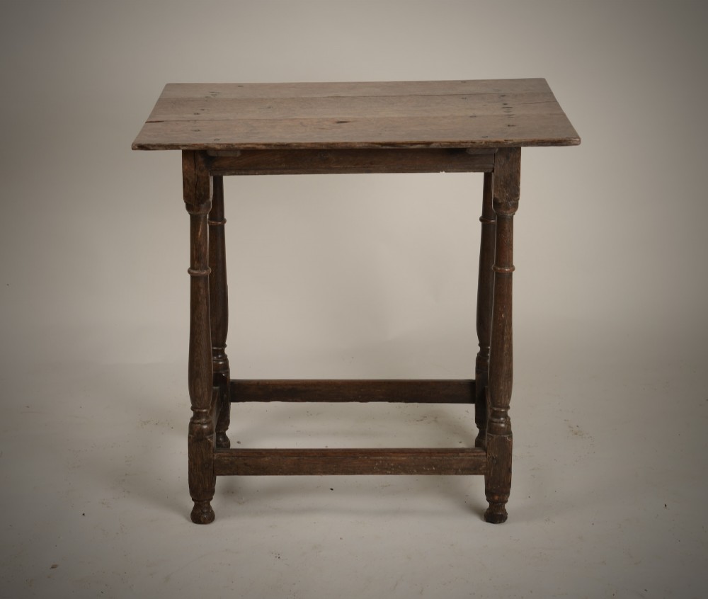 An early 18th-century dark oak tavern table featuring a rectangular plank top, turned legs, and a low box stretcher. View II