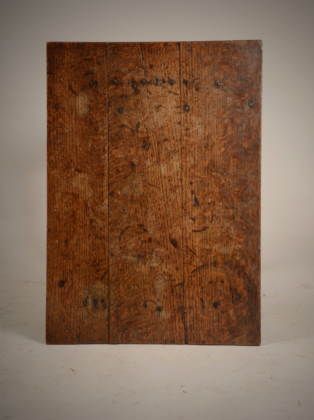 An early 18th-century dark oak tavern table featuring a rectangular plank top, turned legs, and a low box stretcher. View III