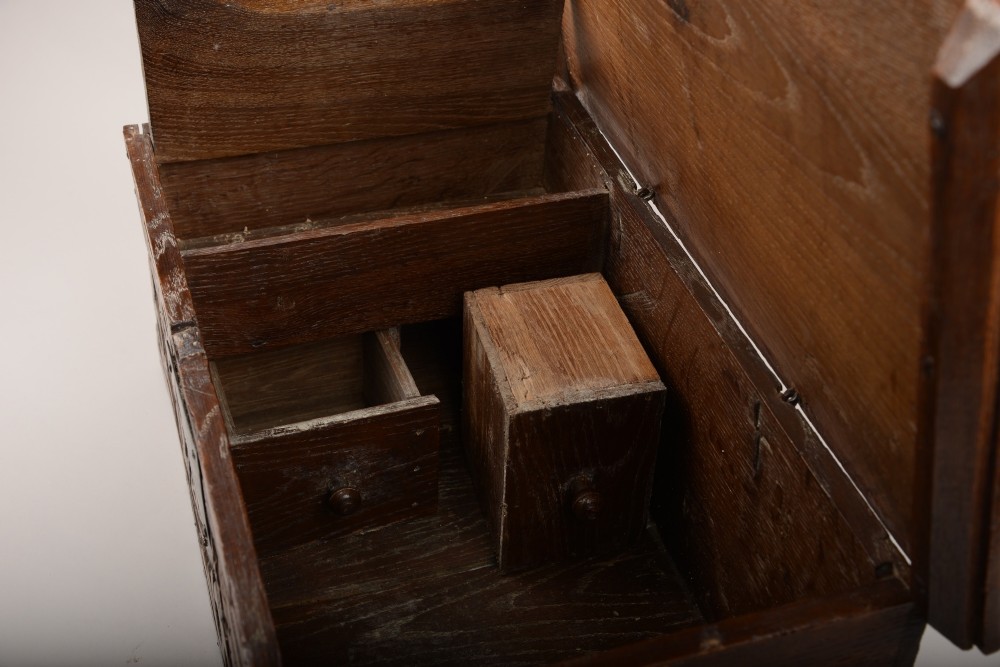 A seventeenth-century dark oak table box with relief-carved leaf and botanical scrollwork on the front panel and a central iron escutcheon plate. View III