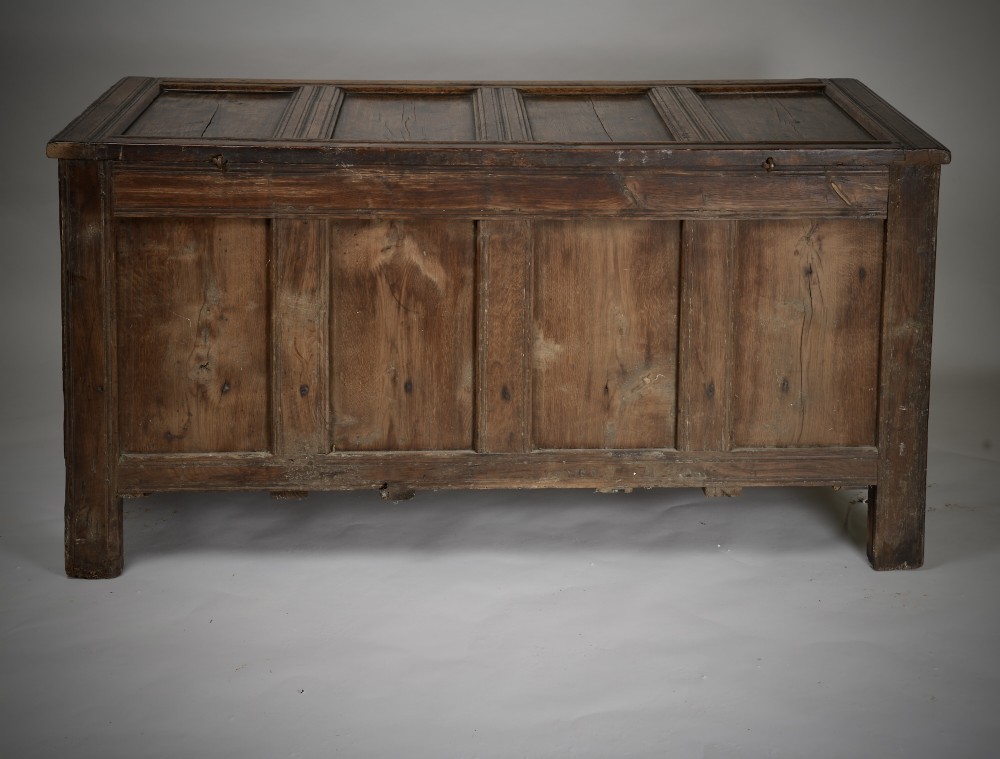 A seventeenth-century dark oak mule chest featuring four carved front panels, three lower drawers, and a carved top frieze with the initials WB and date 1679. View VIII