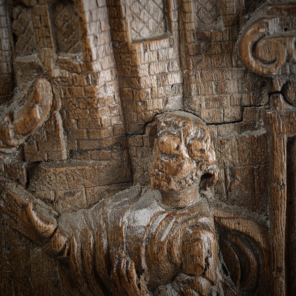 A sixteenth-century rectangular carved oak relief panel depicting a standing soldier with a staff addressing a kneeling figure within an arched architectural backdrop. View III