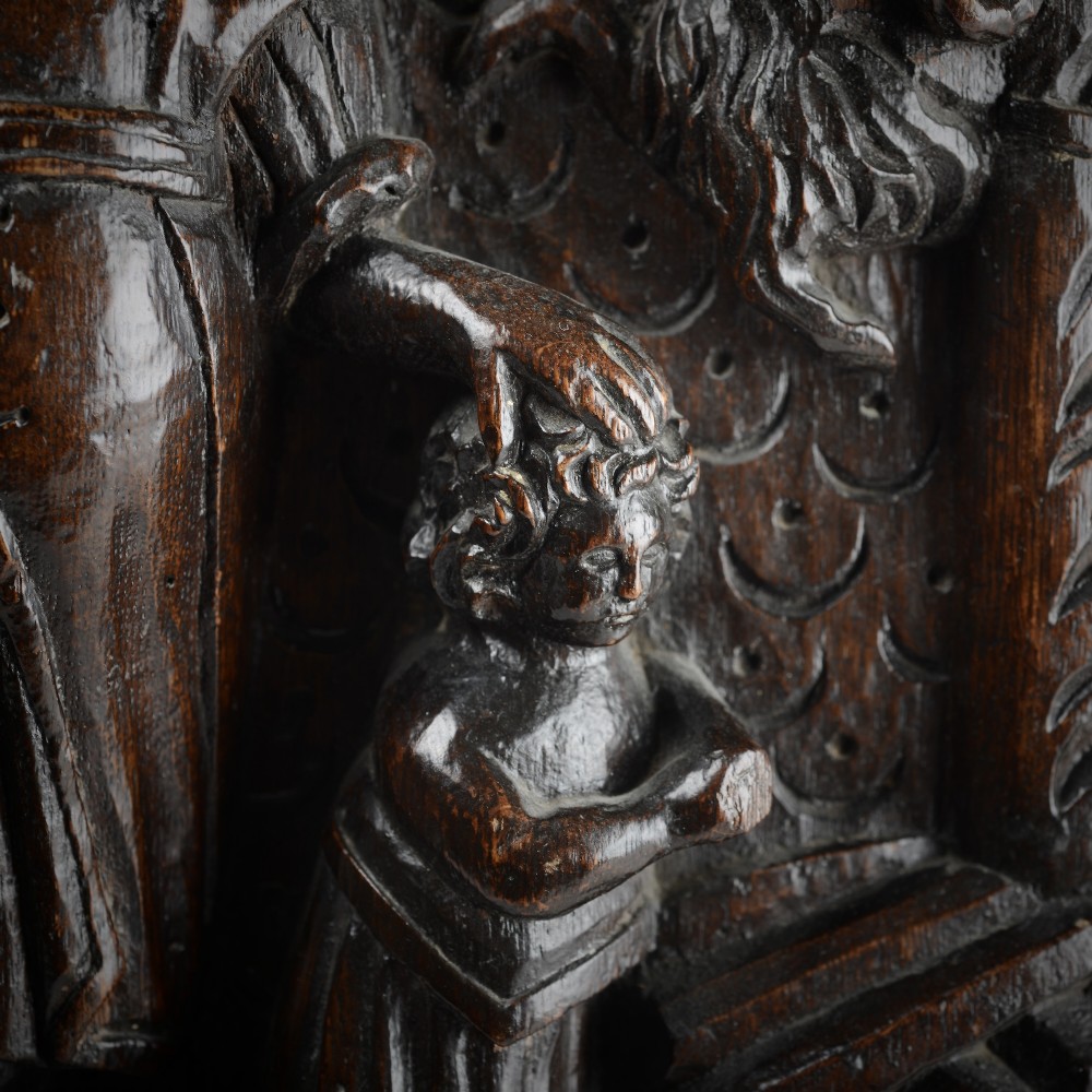 A square dark oak timber panel featuring a hand-carved relief depicting the biblical scene of Abraham and Isaac. View V