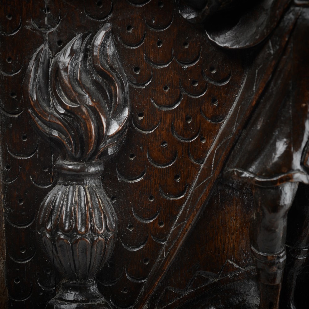 A square dark oak timber panel featuring a hand-carved relief depicting the biblical scene of Abraham and Isaac. View VI
