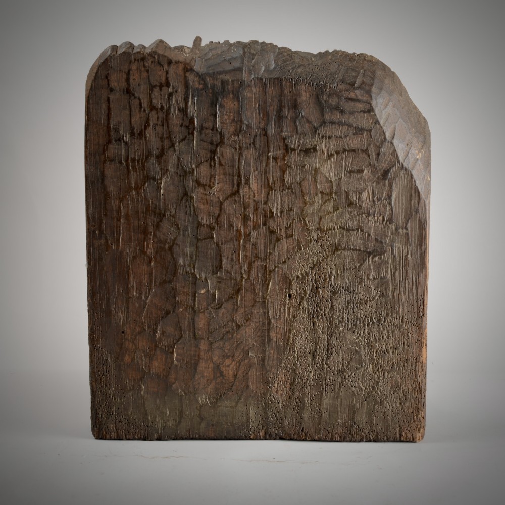 A late medieval carved wooden relief depicting the nativity with Mary, Joseph, and the Christ child under a thatched roof structure with traces of original polychrome paint. View II