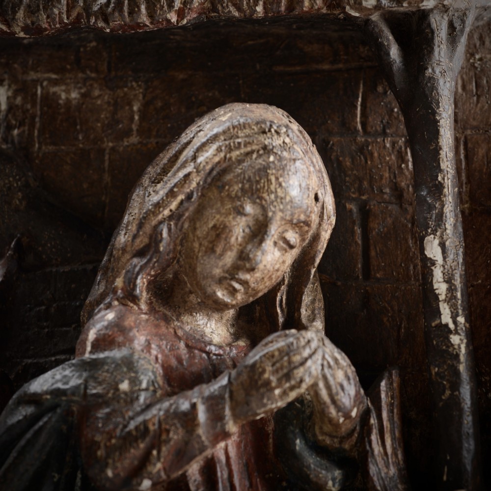 A late medieval carved wooden relief depicting the nativity with Mary, Joseph, and the Christ child under a thatched roof structure with traces of original polychrome paint. View III