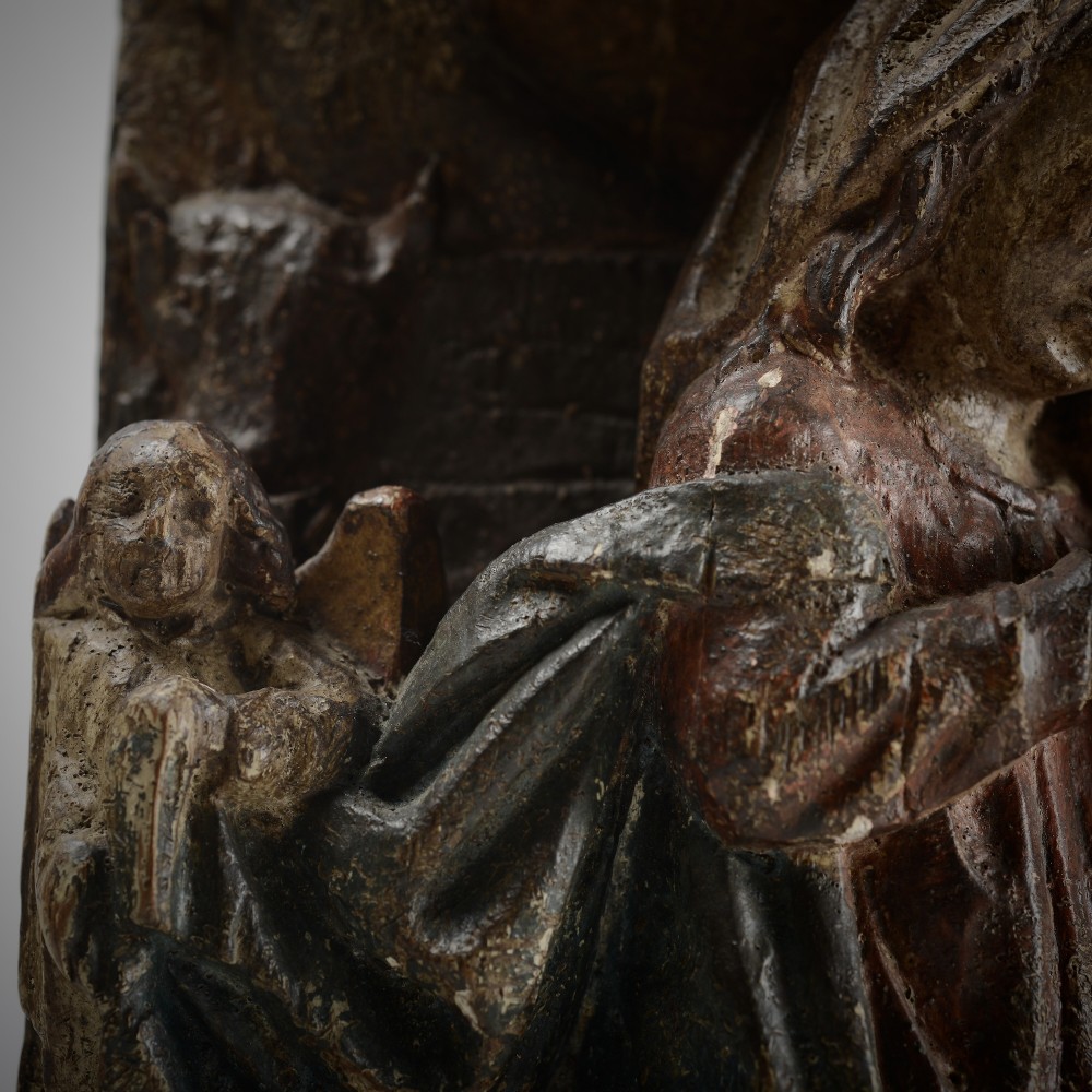 A late medieval carved wooden relief depicting the nativity with Mary, Joseph, and the Christ child under a thatched roof structure with traces of original polychrome paint. View V