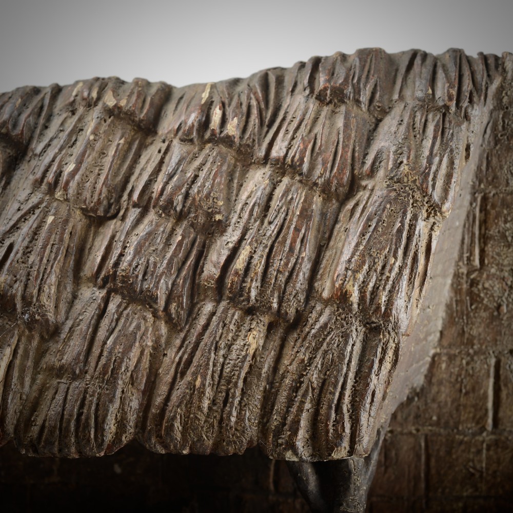 A late medieval carved wooden relief depicting the nativity with Mary, Joseph, and the Christ child under a thatched roof structure with traces of original polychrome paint. View VII