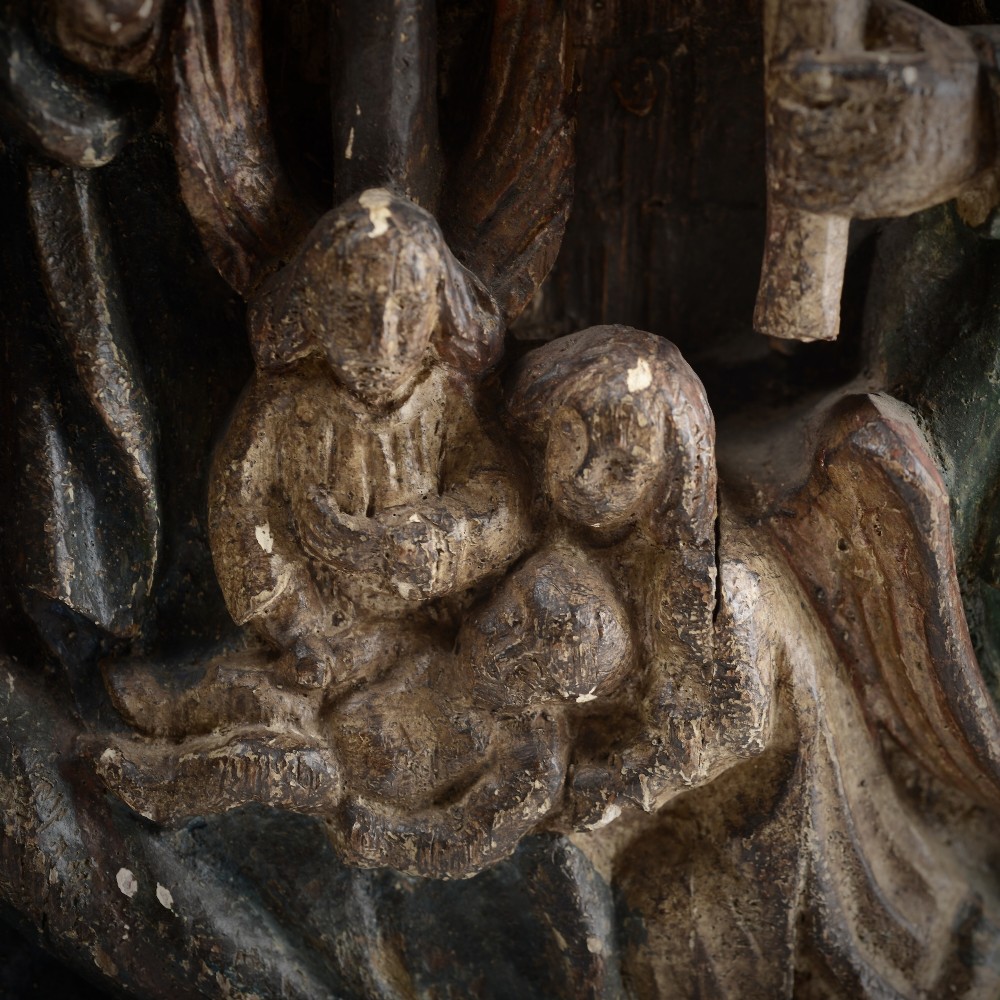 A late medieval carved wooden relief depicting the nativity with Mary, Joseph, and the Christ child under a thatched roof structure with traces of original polychrome paint. View VIII