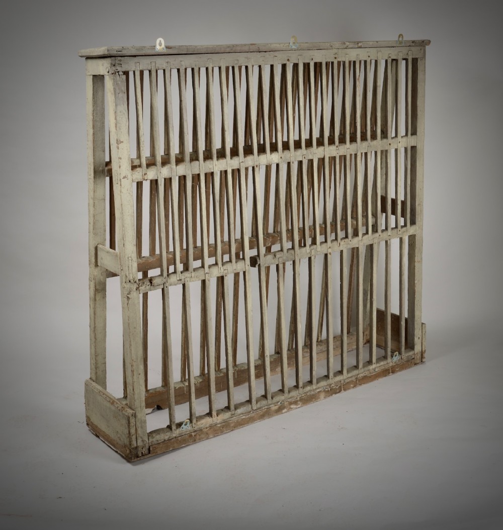 A two-tier painted wooden country house plate rack featuring a distressed off-white finish and vertical slotted spindles. View II