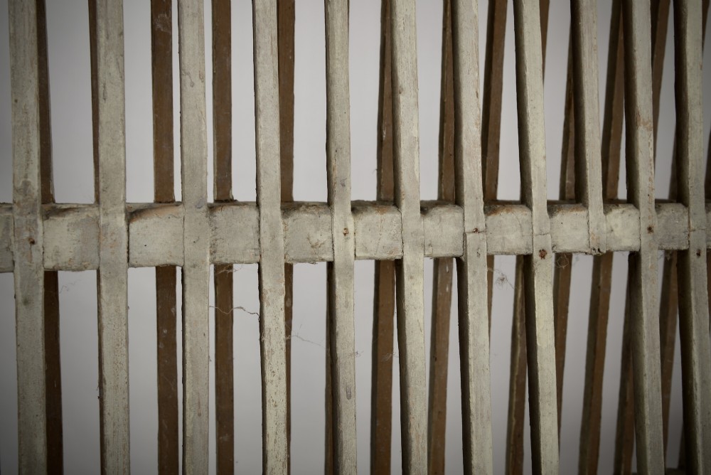 A two-tier painted wooden country house plate rack featuring a distressed off-white finish and vertical slotted spindles. View III