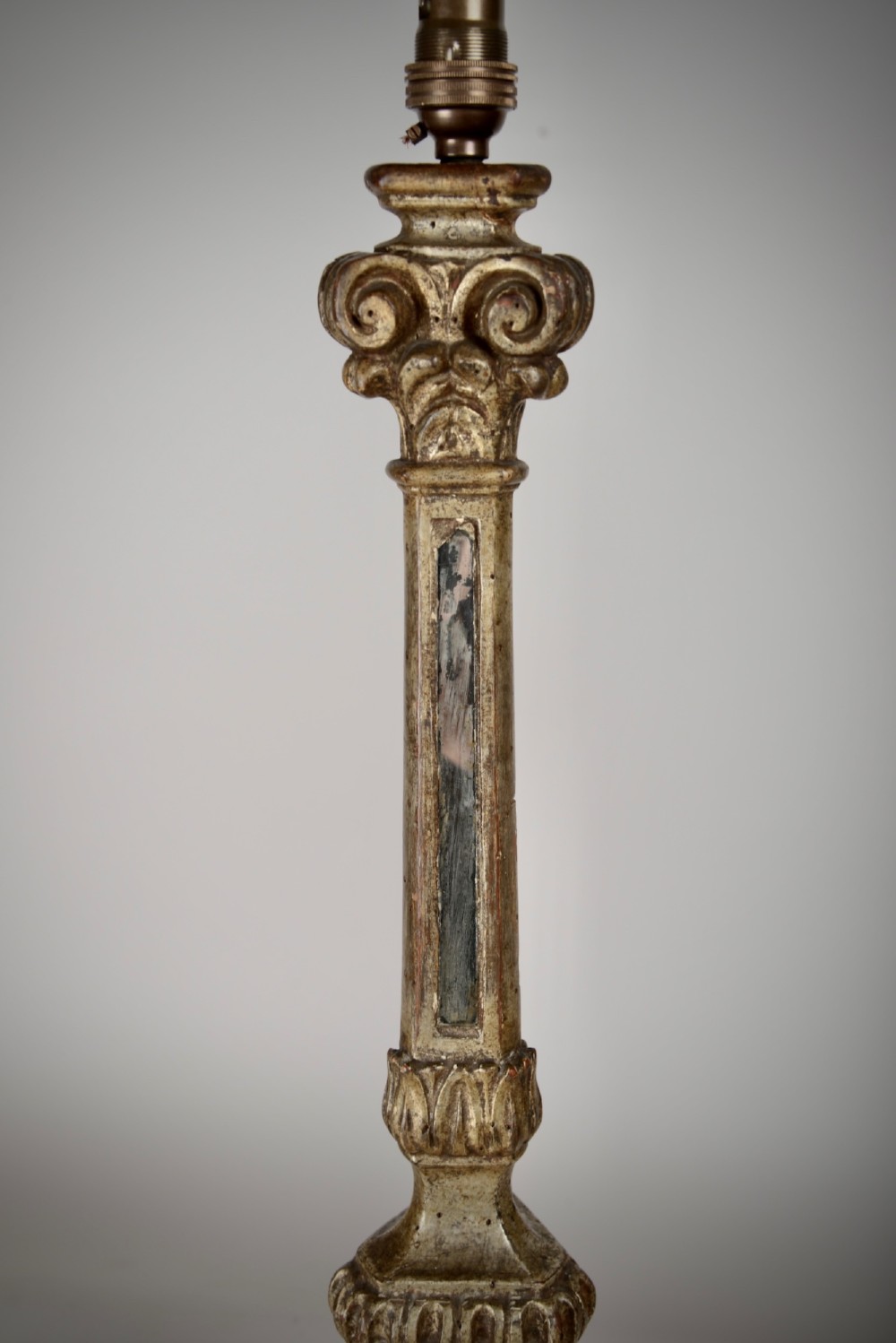 A tall table lamp featuring an 18th-century Italian carved giltwood candlestick base paired with a neutral linen drum shade. View IV
