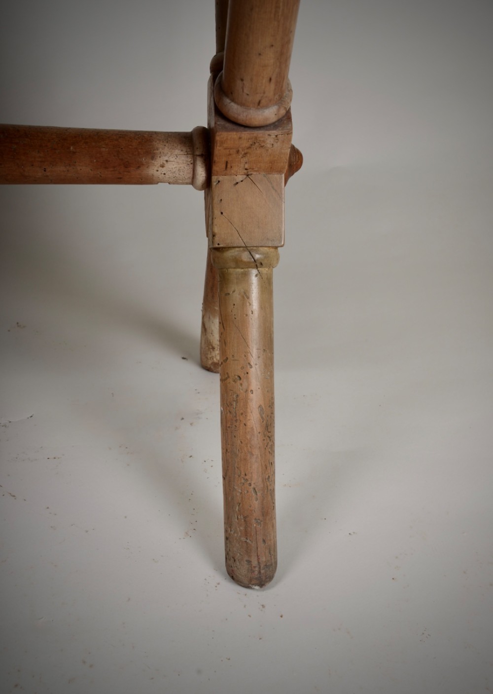 An antique rustic wooden tavern table featuring a rectangular plank top resting on an X-frame trestle base joined by a turned central stretcher. View IV