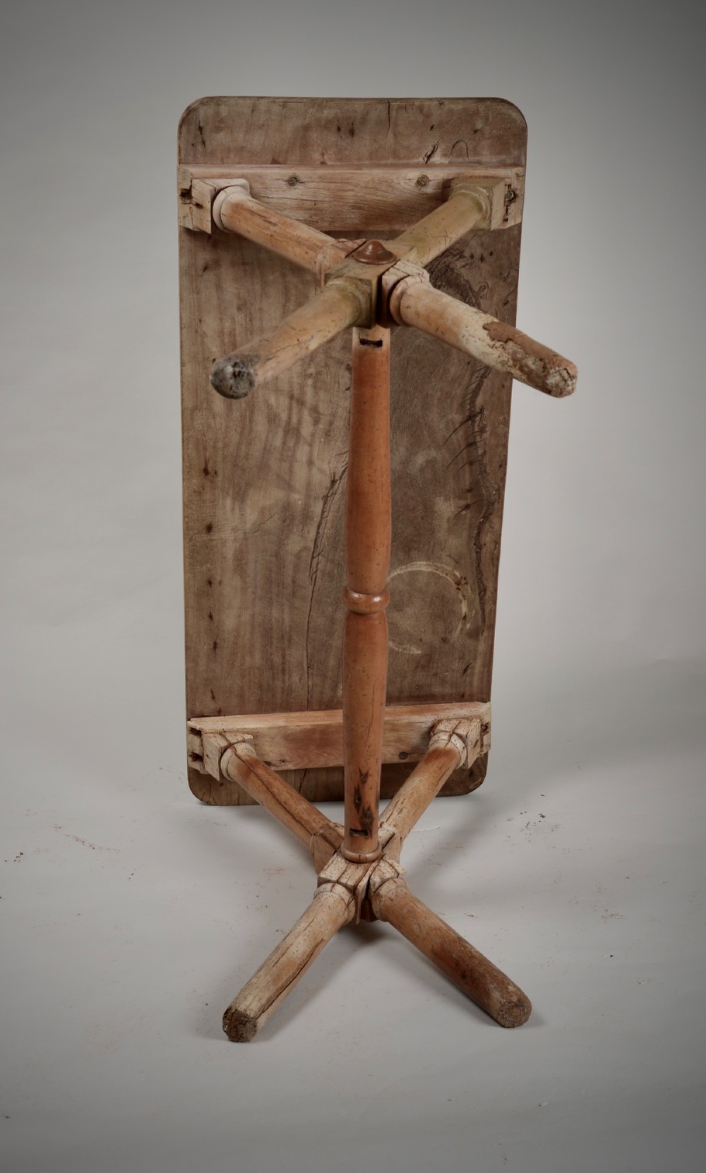An antique rustic wooden tavern table featuring a rectangular plank top resting on an X-frame trestle base joined by a turned central stretcher. View VII