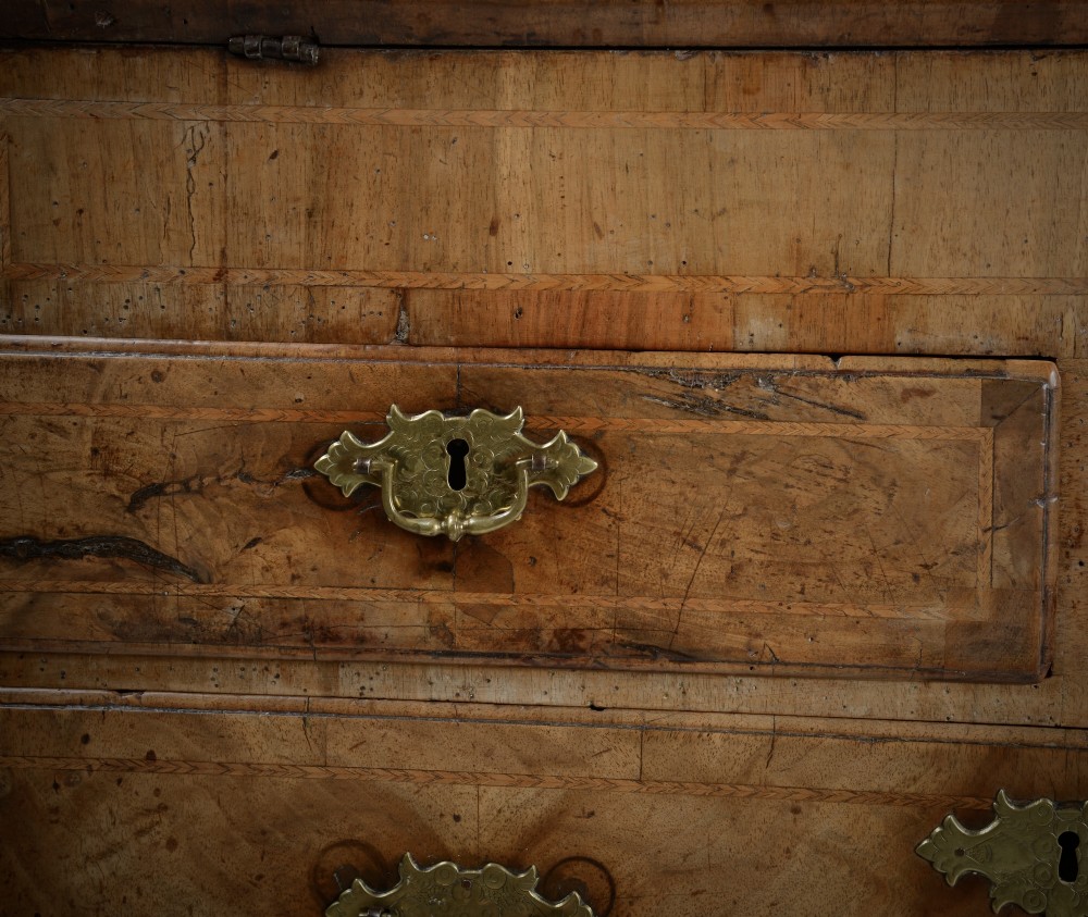 An 18th-century George II burr walnut bureau featuring a sloped fall-front flap above four graduated drawers with brass handles and bracket feet. View IX