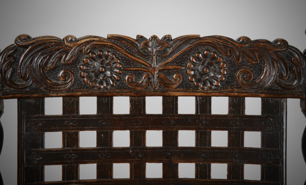 A dark walnut Charles II style open armchair featuring intricate barley twist uprights, a carved floral cresting rail, a slatted timber lattice back, and turned stretchers. View VII