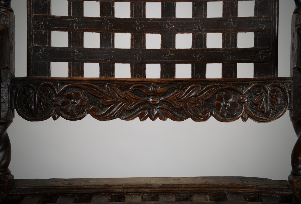 A dark walnut Charles II style open armchair featuring intricate barley twist uprights, a carved floral cresting rail, a slatted timber lattice back, and turned stretchers. View XI